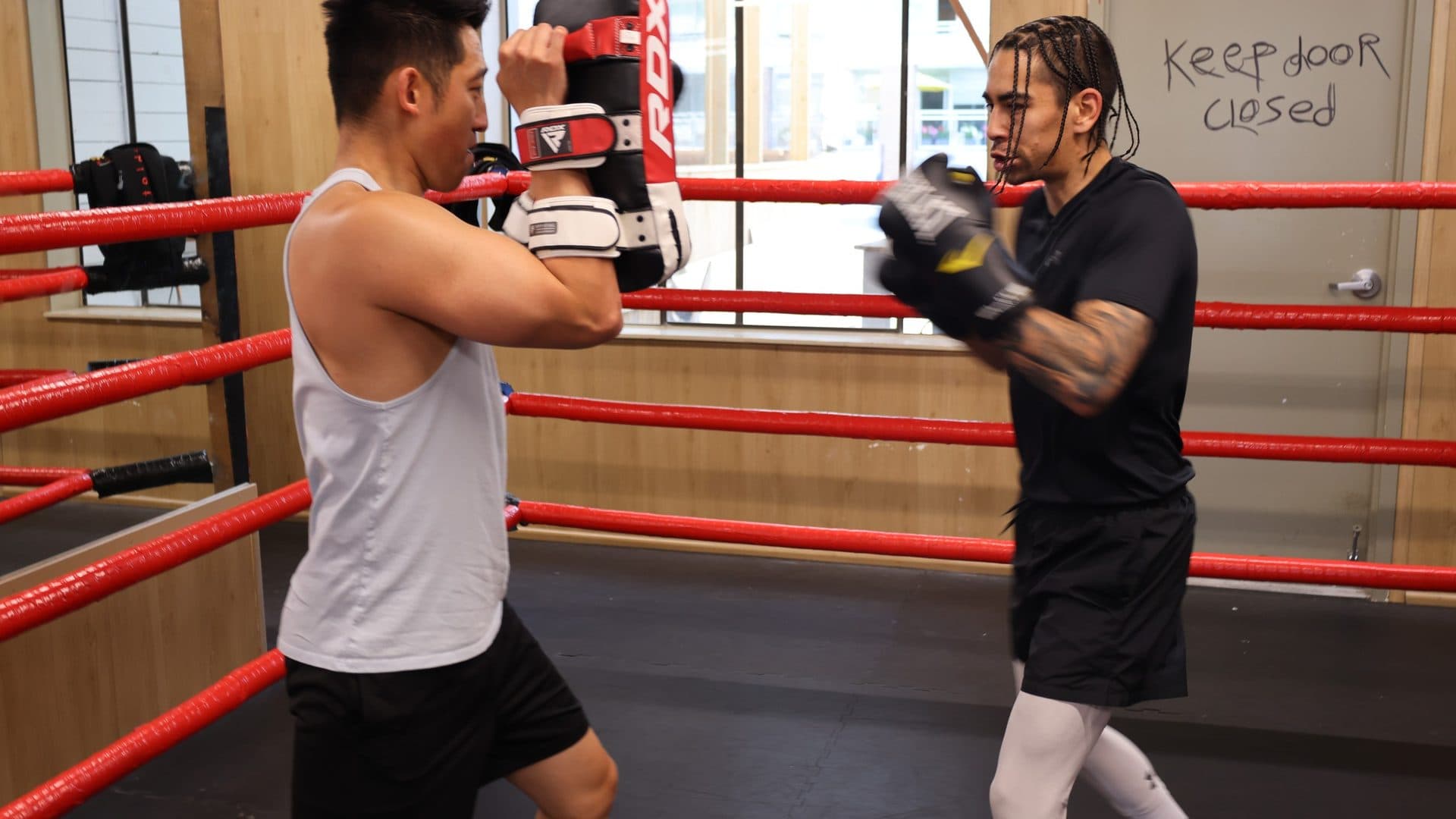 weight loss gym white rock at Kingdom Athletics: a member throwing a combination on pads with a coach