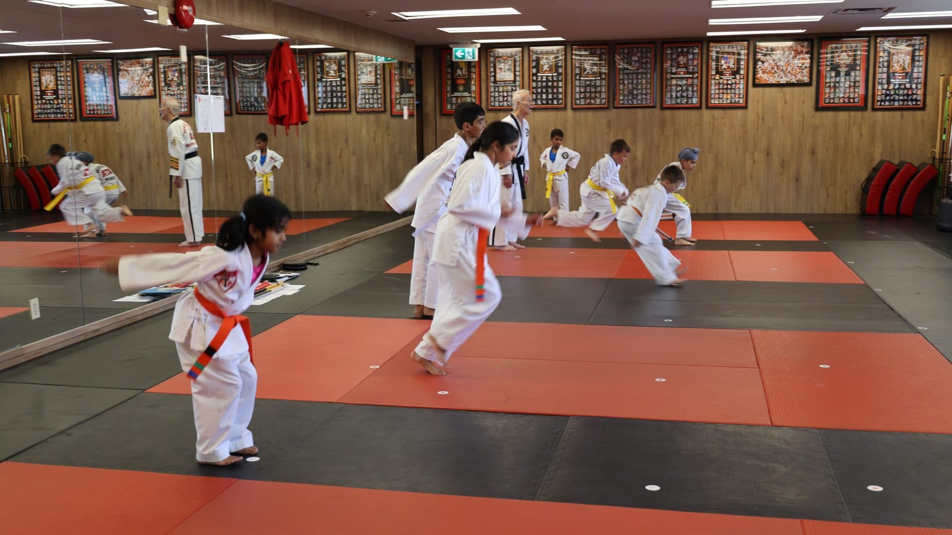 after school programs south surrey at Kingdom Athletics: kids practising kicks in an after school taekwondo class